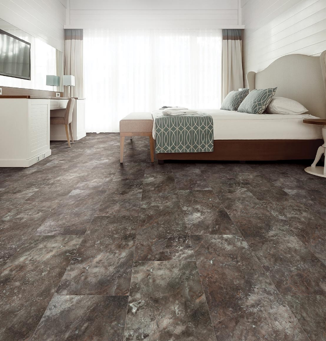 Warm slate grey patterned stone look lvt floors create a clean, earthy aesthetic that brings tranquility to a modern white bedroom.